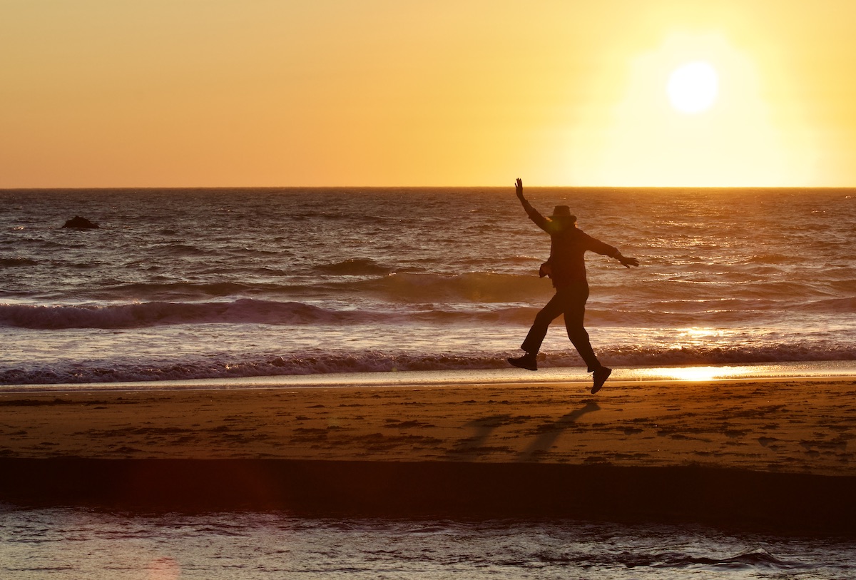 woman dances on beach