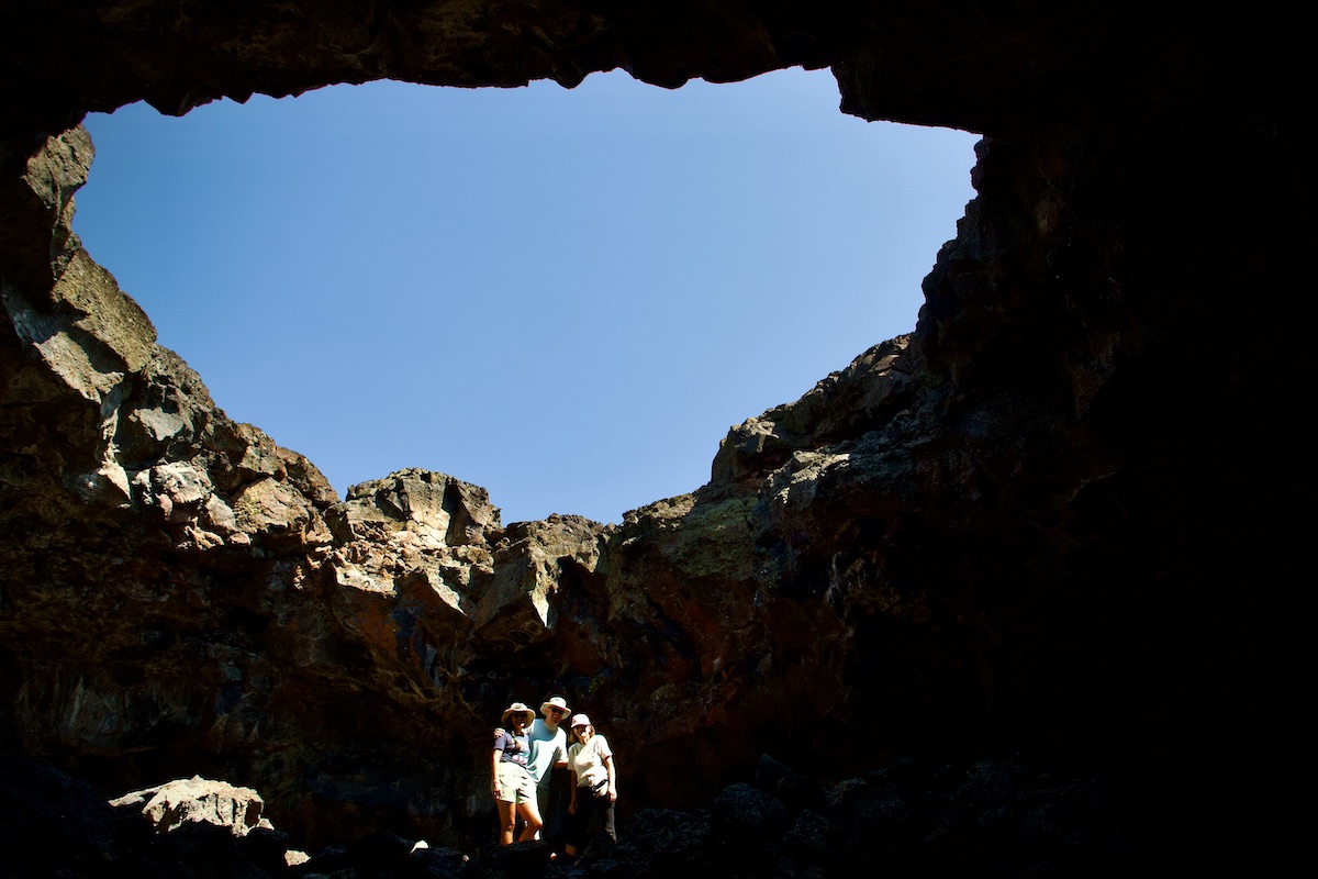 people pose in a cave