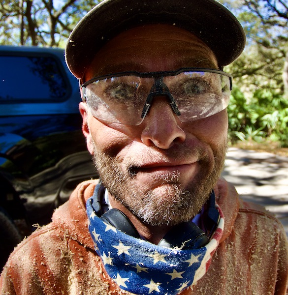 crazy-looking man covered in sawdust