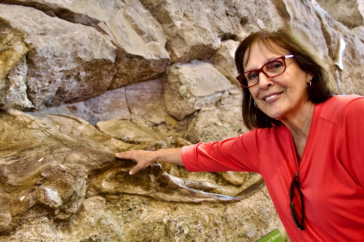 woman touching fossil