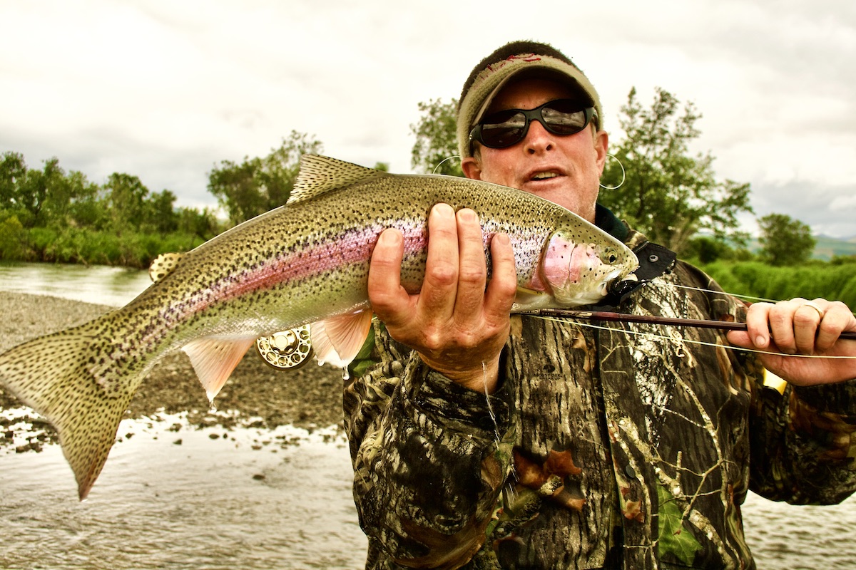 man with rainbow trout