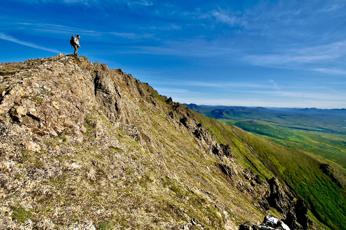 man on mountain summit