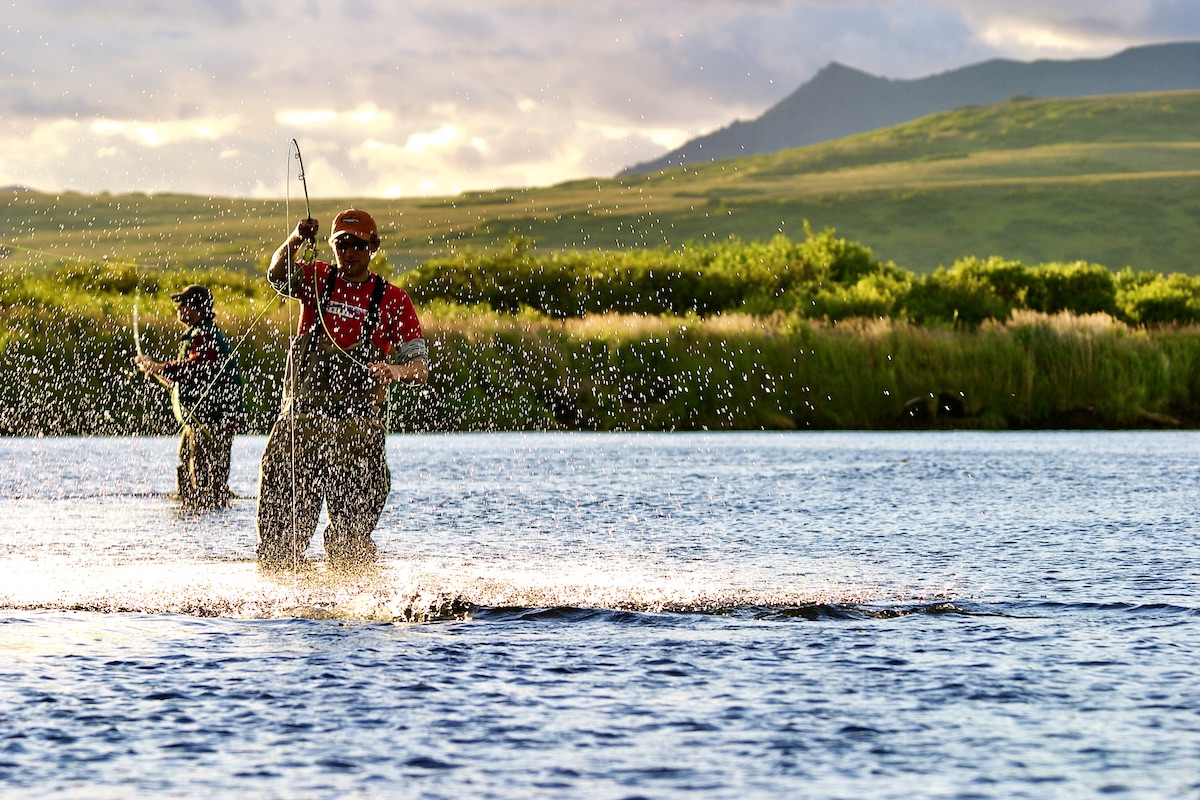 fly fisherman fighting fish