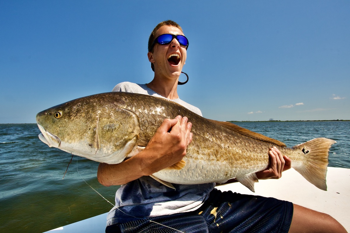 happy man with big redfish