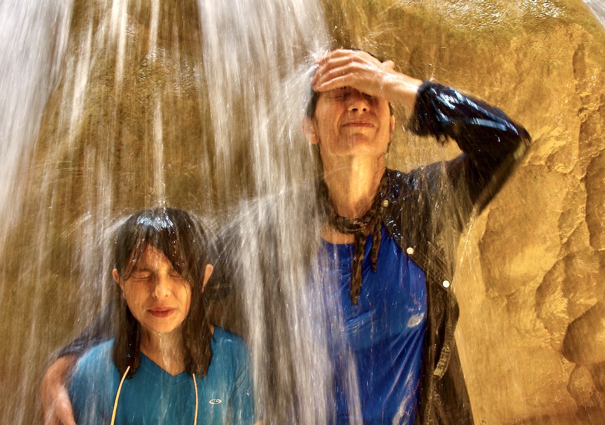 two females under a waterfall