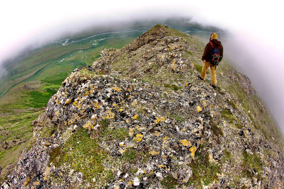 two hikers on a mountaintop in the fog